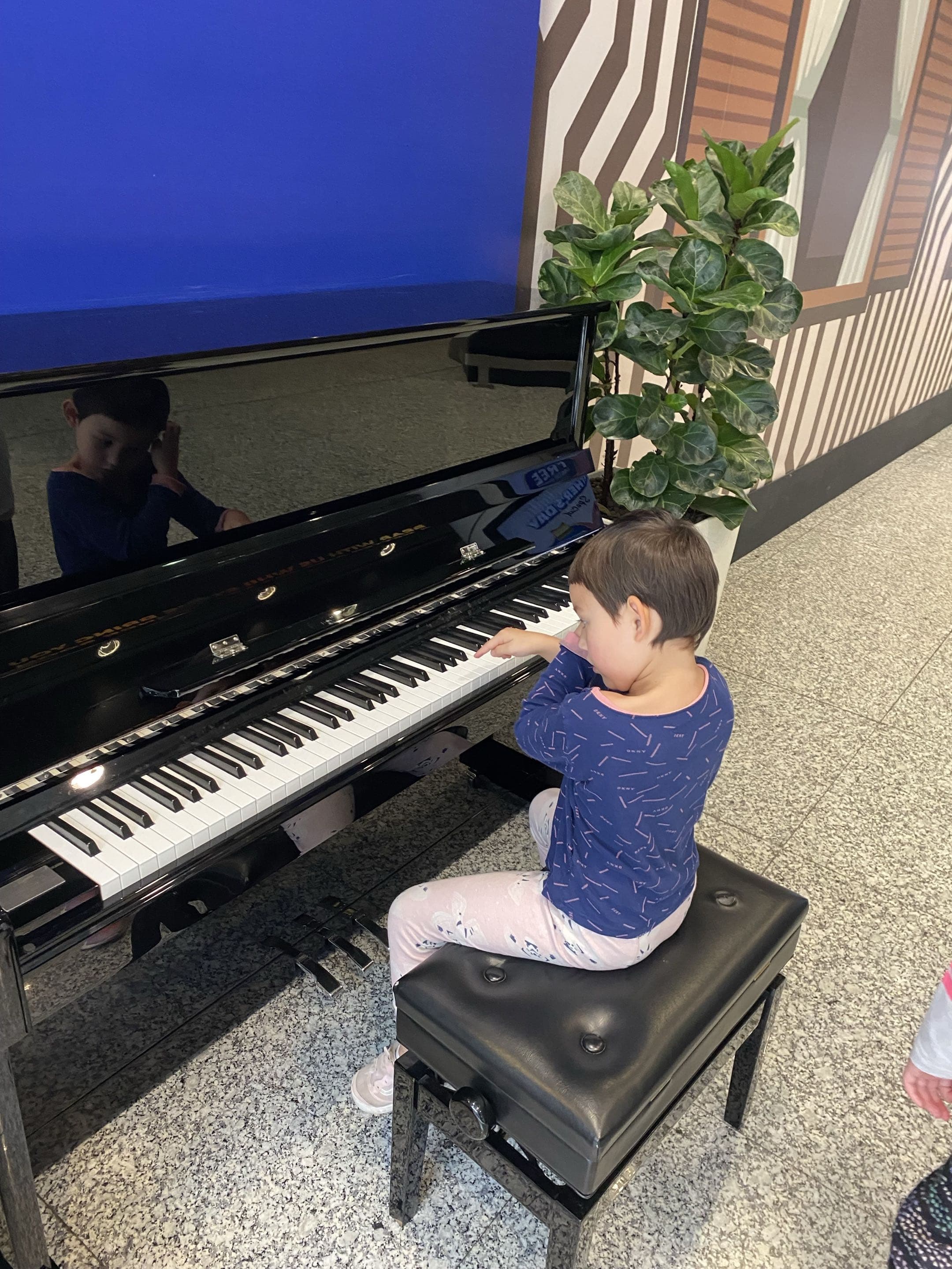 Young student exploring the piano keys